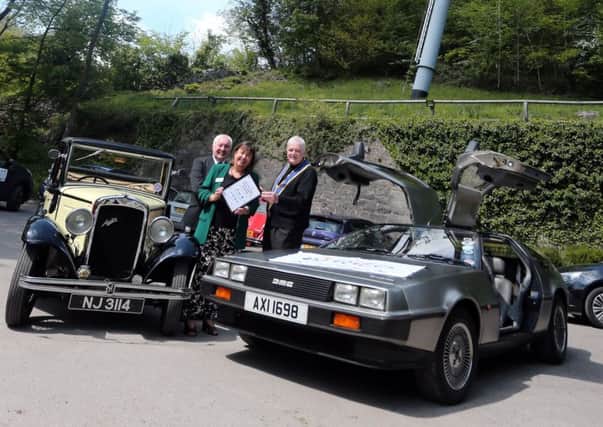Simone Enefer-Doy cheif excecutive of the charity Lifelites hands over a certificate to Chris Palmham master elect classic cars lodge looking on is Philip Marshall provincial grand master of Nottinghamshire.