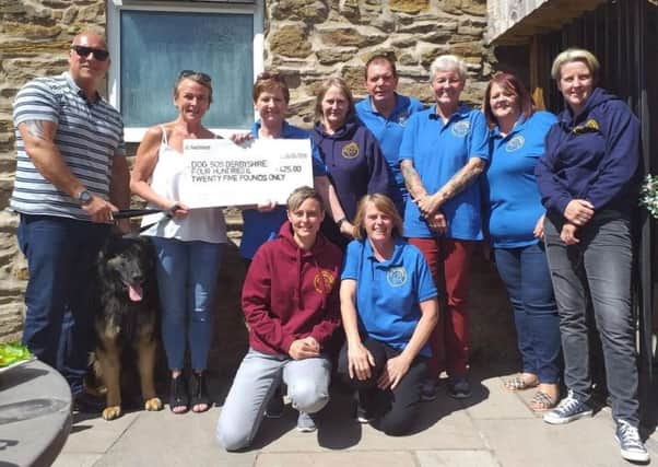 Steve and Sue Schofield present a cheque to Dog SOS Derbyshire.