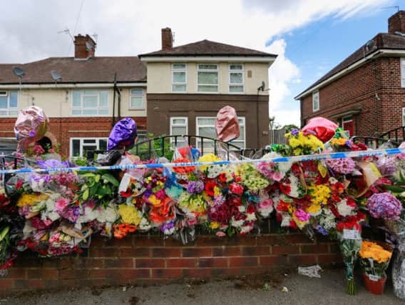 Floral tributes left at the scene in Shiregreen. Photo - SWNS