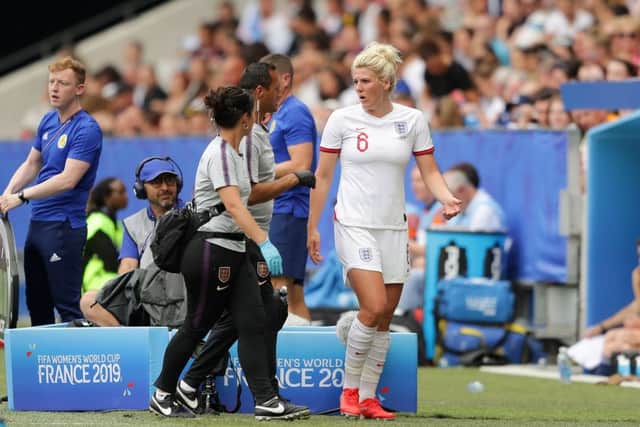 NICE, FRANCE - JUNE 09: Millie Bright of England receives medical attention during the 2019 FIFA Women's World Cup France group D match between England and Scotland at Stade de Nice on June 09, 2019 in Nice, France. (Photo by Richard Heathcote/Getty Images)