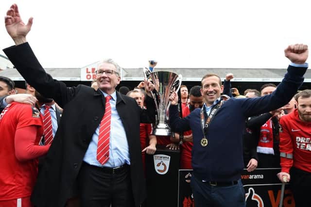 LONDON, ENGLAND - APRIL 27: Nigel Travis, Chairman of Leyton Orient, and Justin Edinburgh, Manager of Leyton Orient celebrate with the Vanarama National League Trophy as they celebrate promotion to League 2 following their result in the Vanarama National League match between Leyton Orient and Braintree Town at Brisbane Road on April 27, 2019 in London, England. (Photo by Harriet Lander/Getty Images)