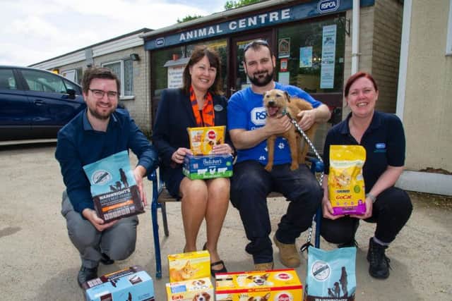 Steph McCawley, far right, and Graham Carter, second right, from the RSPCA Chesterfield and North Derbyshire branch, are pictured receiving animal food from Chris Bray and Linda Linacre, of housebuilder Bellway East Midlands.Also pictured is Pollyana, a 12-year-old Lakeland Terrier Patterdale cross.
