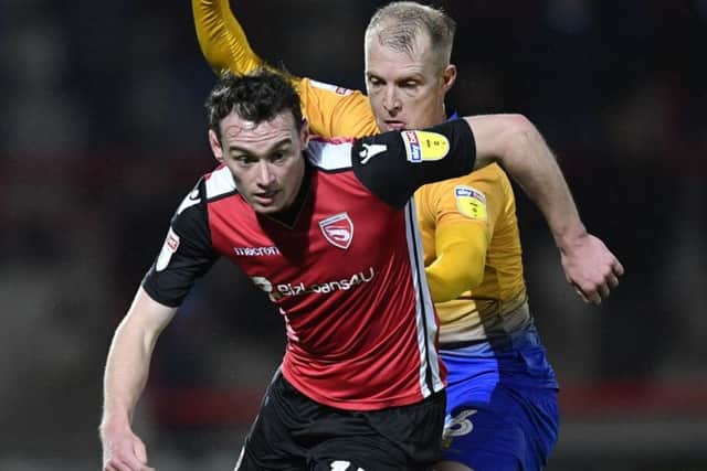 Mansfield Town's Neal Bishop tussles for the ball with Morecambe's Liam Mandeville :Picture by Steve Flynn/AHPIX.com, Football: Skybet League 2  match Morecambe -V- Mansfield Town at Globe Arena, Morecambe, Lancashire, England on copyright picture Howard Roe 07973 739229