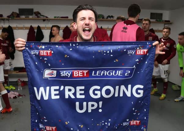 NORTHAMPTON, ENGLAND - APRIL 09:  David Buchanan of Northampton Town celebrates promotion to League One after the Sky Bet League Two match between Northampton Town and Bristol Rovers at Sixfields Stadium on April 9, 2016 in Northampton, England.  (Photo by Pete Norton/Getty Images)