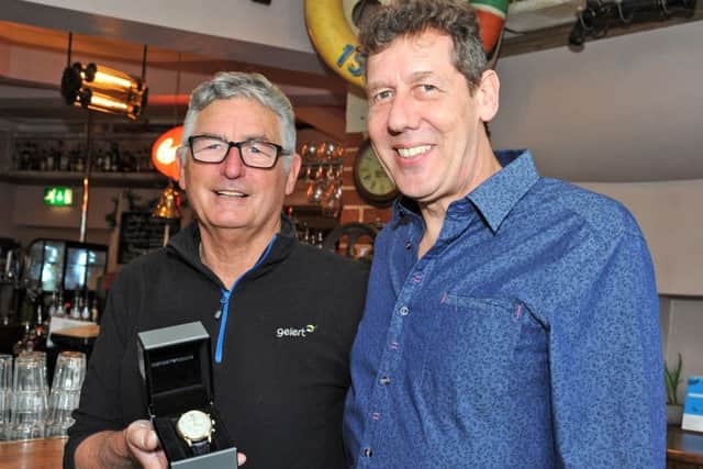 Laurence Fenn, left, is presented with a gold watch to mark 20 years with the Chesterfield bar, Chandlers, which celebrates its 20th birthday this year.  Lawrence has work with Landlord, Roger Butler, from day one, and has completed 48 years in total as a doorman in the town.