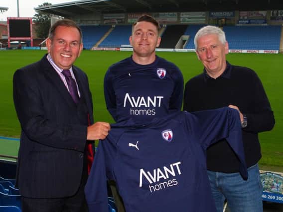 Town player Sam Wedgbury sporting the new training kit, flanked by Stuart Rowlands of Avant Homes (left) and Spireites commercial manager Jim Brown (Pic: Tina Jenner)