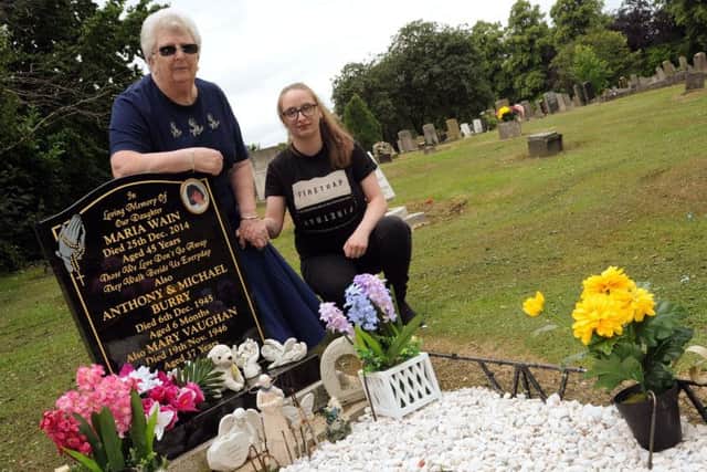 Pamela Wain with her granddaughter, Holly Symour, at her daughter Maria's grave. Pic: Anne Shelley.