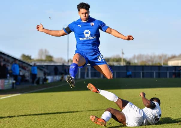 Chesterfield's Josef Yarney jumps over a tackle from FC Fylde's Zaine Francis-Angol: Picture by Steve Flynn/AHPIX.com, Football: Vanarama National League match AFC Fylde -V- Chesterfield FC at Mill Farm, Kirkham, Lancashire, England on copyright picture Howard Roe 07973 739229