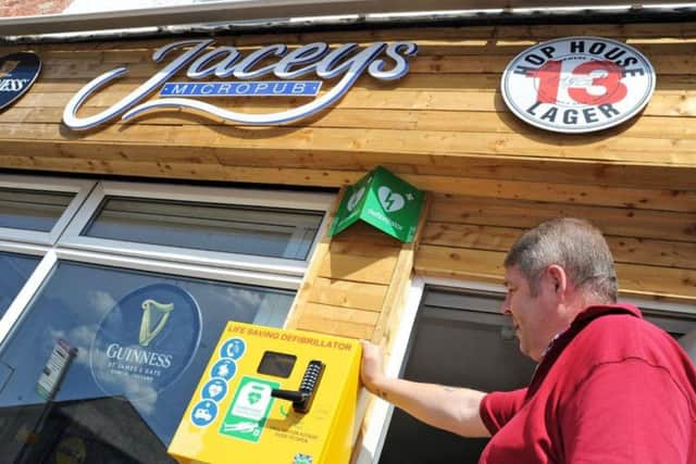 Stephen Savage outside Jacey's Micropub with the new defibrillator.