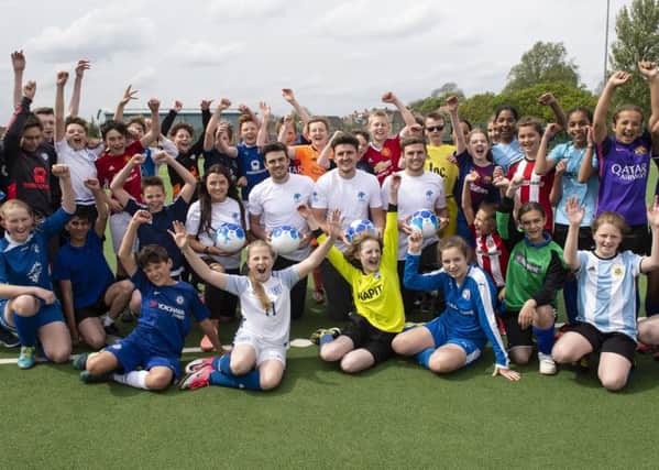 Excited, football-mad youngsters at St Mary's Catholic High School in Chesterfield with England defender Harry Maguire. (PHOTO BY: Daniel Hanbury/Stella Pictures Ltd)