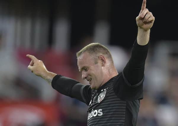 Wayne Rooney  of DC United celebrates after a goal was scored during the DC United vs the Vancouver Whitecaps FC match in Washington DC on July 14, 2018. (Photo by ANDREW CABALLERO-REYNOLDS / AFP/Getty Images)