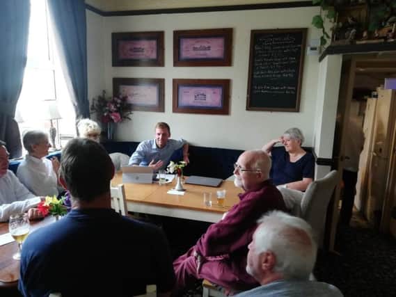 North East Derbyshire MP Lee Rowley talking with residents at a meeting.