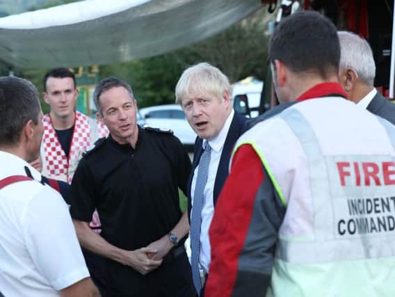 Prime Minister Boris Johnson met with emergency services personnel during a visit to Whaley Bridge last week. Photo - YUI MOK/AFP/Getty Images