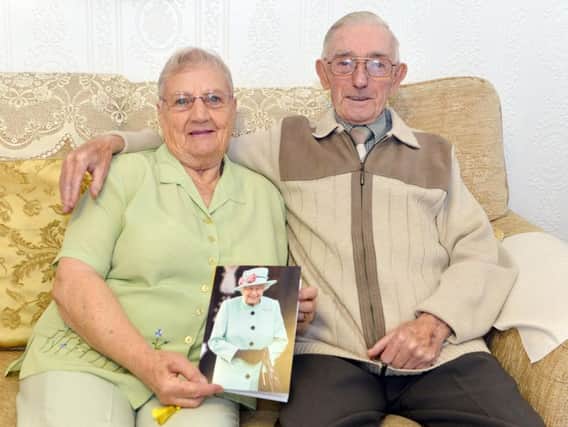 Rita and William Blanksby with a card from the Queen to celebrate their 65th wedding anniversary. Picture by Brian Eyre.