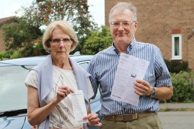 Philip and Janette Court with the parking ticket claiming they'd left the site and their till receipt proving they were inside shopping.