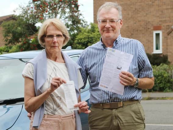Philip and Janette Court with the parking ticket claiming they'd left the site and their till receipt proving they were inside shopping.