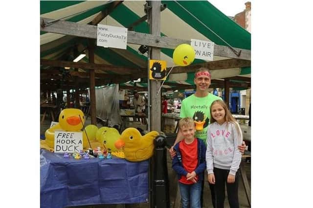 Lee Waterhouse with his daughter Abigale - whose phone was stolen - and his son Lucas at the duck stall in Chesterfield town centre.