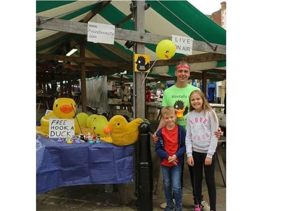 Lee Waterhouse with his daughter Abigale - whose phone was stolen - and his son Lucas at the duck stall in Chesterfield town centre.