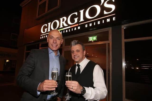 Steve Zsirai (right) toasts the launch of Giorgios five years ago with World Cup referee Howard Webb.