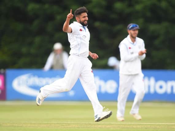 Anuj Dal celebrates taking a wicket for Derbyshire.