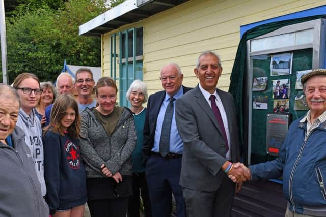 Hunloke Community Garden:  Peter Openshaw is shaking hands with Hardyal Dhindsa.  Then from (L/R front row) Paul Nicholls, Kelly-Louise Stevens, Grace, Lisa Blakemore and local County Councillor Dave Allen. (L/R back row) Margaret Kenny, Roger Wilcockson, Bob Wilson and Jude Cornwell.