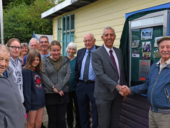 Hunloke Community Garden:  Peter Openshaw is shaking hands with Hardyal Dhindsa.  Then from (L/R front row) Paul Nicholls, Kelly-Louise Stevens, Grace, Lisa Blakemore and local County Councillor Dave Allen. (L/R back row) Margaret Kenny, Roger Wilcockson, Bob Wilson and Jude Cornwell.