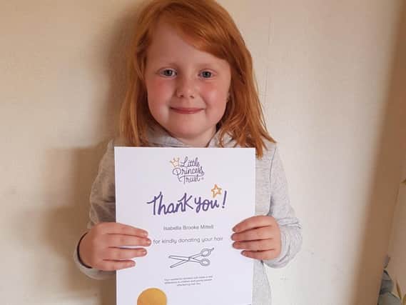 Isabella Brooke with her certificate from the Little Princess Trust.