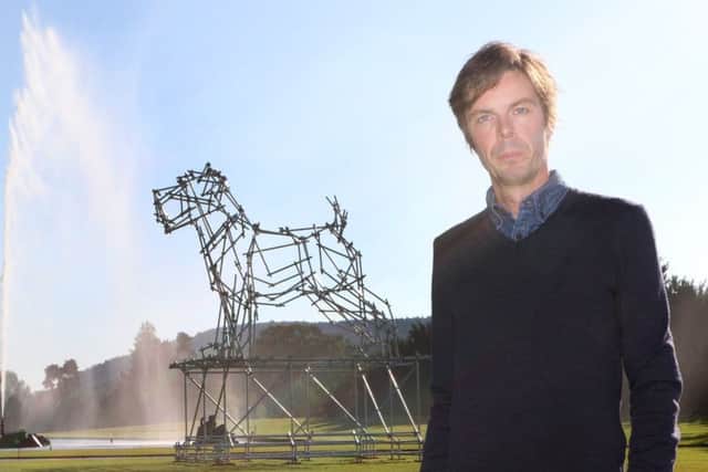 Ben Long with his giant dog sculpture