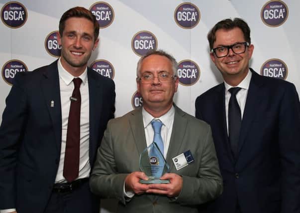 Phil Lucas (centre) with his award, flanked by Chris Woakes and a NatWest representative. (PHOTO BY: Steve Bardens/Getty Images)
