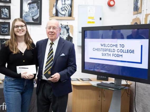 Frank Gorman presents a cheque to sixth form student Lucy Herbert.