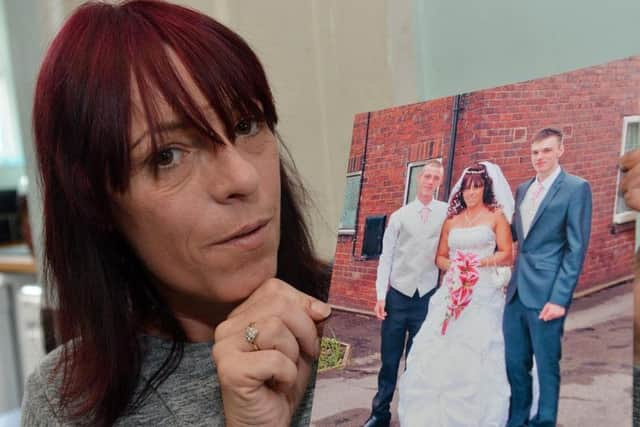 Sharon Whitford holding a picture of her son Marc Maltby - in the white top - who was found dead in Nottingham Prison in October 2017.