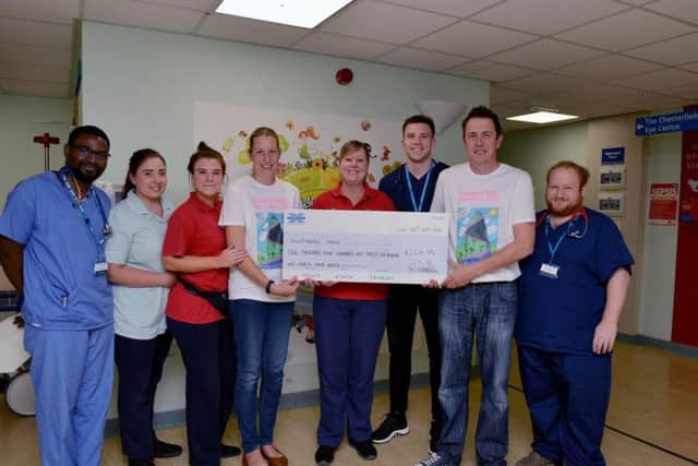 Sharon and Darren Morrell present a cheque to staff on the Nightingale Ward.