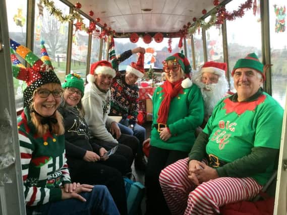 Elves pop down to join Santa on his cruise down the canal.