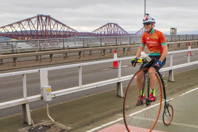 Richard Thoday crossing the Forth Road Bridge in Scotland during his record-breaking ride. (PHOTO BY: Katielee Arrowsmith, SWNS)