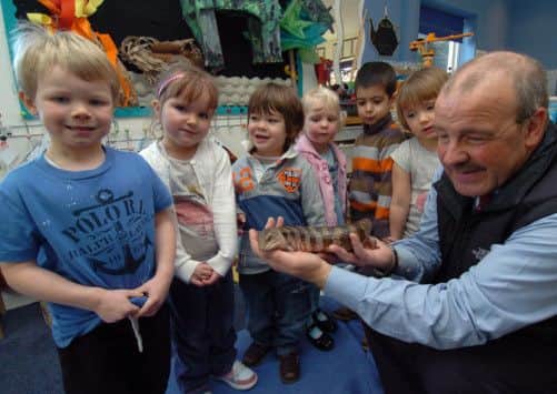 St Anselms Nursery Bakewell Derbyshire. Zoologist James McKay showing youngsters some rare lizards as part of their dinosaur project at school.