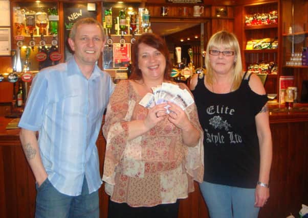 Pictured, centre, is Joanne Edwards, Ashgate Hospices Head of Fundraising, receiving a donation of £400 from Shane & Lesley Osbiston, managers of the Wheatsheaf Inn, Newbold, Chesterfield, on behalf of the pub quiz regulars.