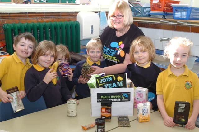 Barbara Daniels of Matlock's Fair Trade Fortnight explains Fair Trade shopping to year one and two pupils at Castle View Primary