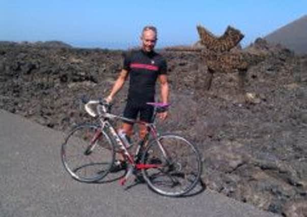 Pictured is Carl Denton who is doing a cycling challenge for the Alzheimer's Society in honour of his late father.