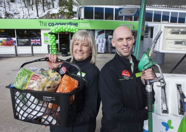 Wirksworth store opening 28.3.13 ... Store Manager Paddy Wright and staff member Julie Spencer unveils new Petrol/Foodstore