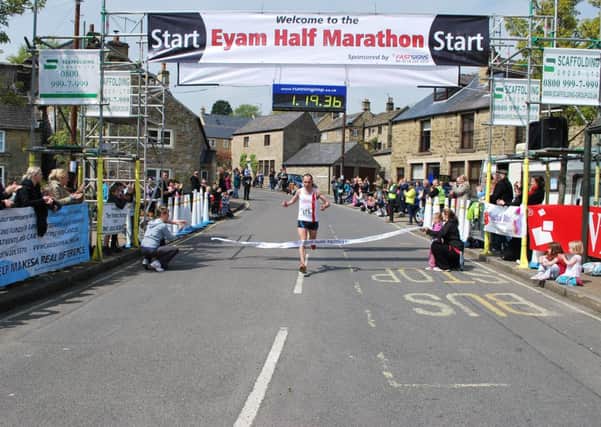 WINNER: Wigan Phoenix runner John Morrissey crosses the line to win the Eyam Half Marathon. Photo contributed.