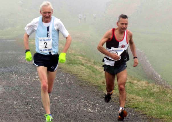 Pictured are Matlock runner Rob Atkin (left) and Peter Bates of Bury as they reach the 11-mile turning point at Parsley Hay in the White Peak Marathon.