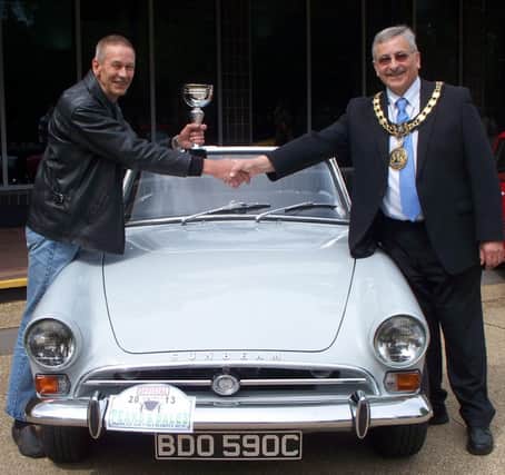 Mayor of the High Peak Councillor Tony Kemp presents the prize for the "car he would most like to go home in" to Richard Burnham and his 1965 Sunbeam Alpine at the 17th Peaks and Dales Run on Sunday, June 16th.