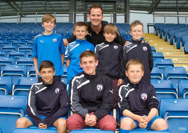 Rising stars: Eight youngsters enrolled into Chesterfield academy pictured alongside Liam Sutcliffe
