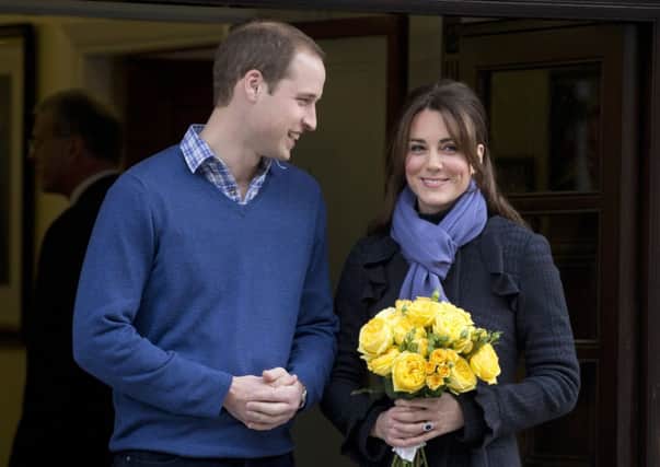 Britain's Prince William stands next to his wife Kate, Duchess of Cambridge as she leaves the King Edward VII hospital in central London, Thursday, Dec. 6, 2012. Prince William and his wife Kate are expecting their first child, and the Duchess of Cambridge was admitted to hospital suffering from a severe form of morning sickness in the early stages of her pregnancy. (AP Photo/Alastair Grant)