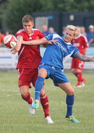 Matlock midfielder Corey Gregory (right) challenges for posession. Photo by Richard Parkes.