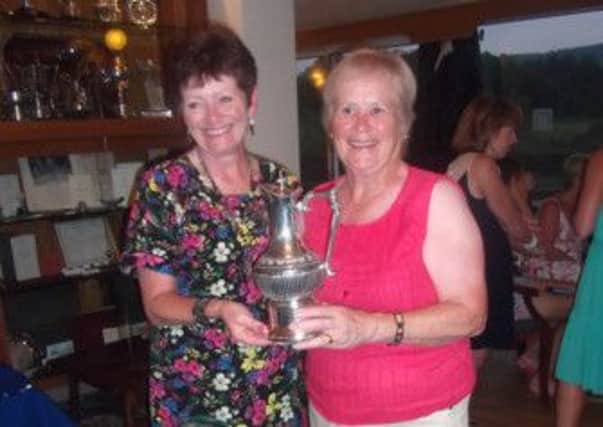 Lady Captain Bridget Watson presents the trophy to Kath Cassidy. Photo contributed.