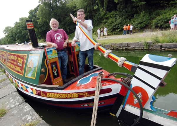 Narrow boat returns to Cromford wharf. Mike Kelley operations manager friends of Cromford canal and Cllr Andy Botham.