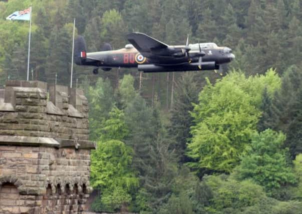 A commemorative Lancaster bomber during a flyover at Derwent Reservior, in the Peak District.