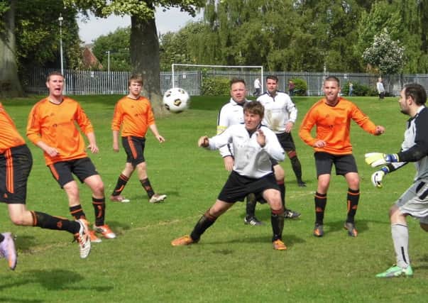 Pictured is Daniel Weatherall, centre, about to score Duckmanton Community's second goal in their 6-1 away victory over Britannia Tupton.