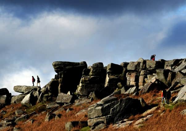 POSS PICTURE POST>>>>   visitors clambering over the rock of  Stanage edge, Derbyshire below..Details Nikon D3s, 300mm f/2.8 at f/9, 1/320s with 400 ISO See Story ?????????? Picture by Chris Lawton
26 Oct  2011